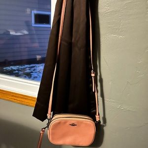 Peach/salmon colored coach wristlet or crossbody bag